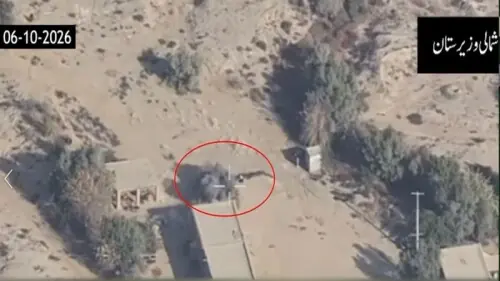 Aerial view of a building and surrounding terrain, with a red circle highlighting a structure or area of interest.