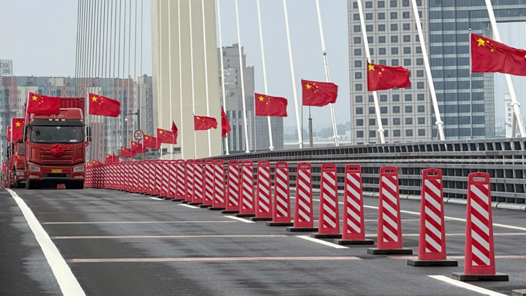 Trucks crossing the New Yalu River Bridge during the opening ceremony on October 15, 2026