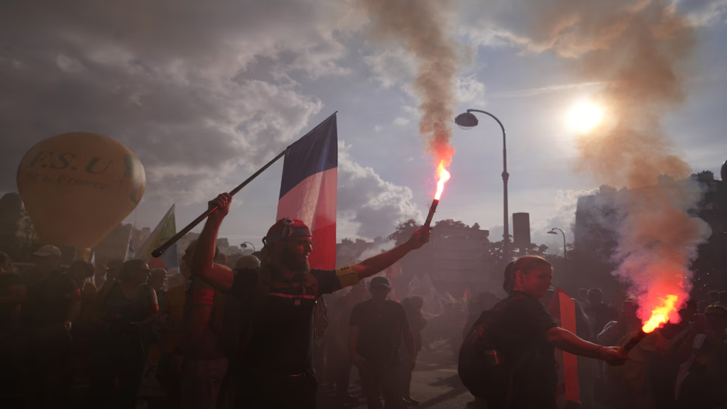 France protests: riot police and demonstrators in Paris as Yellow Vests join students and unions